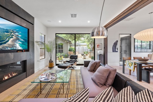 1005 Jewell St, Austin, TX 78704 - living area with recessed lighting, plenty of natural light, wood finished floors, and a fireplace