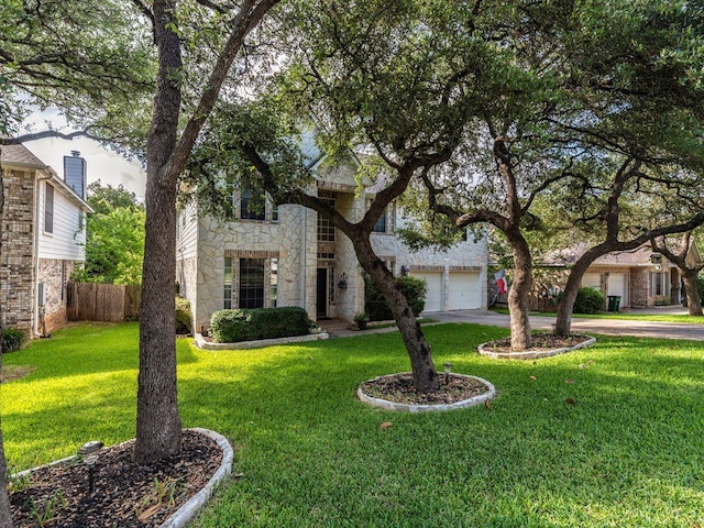 view of front of home featuring a garage and a front lawn