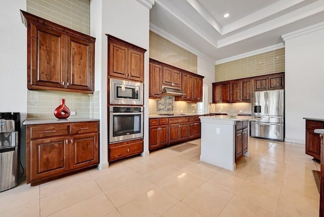 kitchen with tasteful backsplash, light stone counters, stainless steel appliances, a center island, and light tile patterned flooring