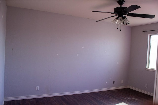 empty room featuring ceiling fan and dark hardwood / wood-style floors