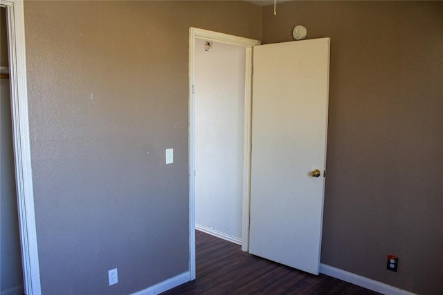 unfurnished bedroom featuring dark wood-type flooring