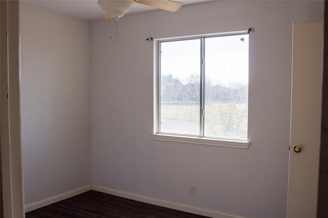 empty room with dark hardwood / wood-style floors and ceiling fan