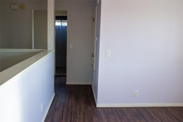 corridor with dark hardwood / wood-style floors