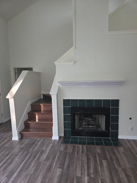 700 N Faircrest Dr, Buda, TX 78610 - detailed view of wood finished floors, a tiled fireplace, and baseboards