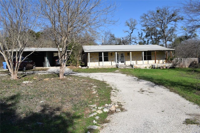 ranch-style house featuring a porch and a front yard