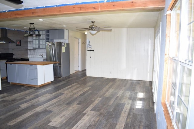 kitchen with stainless steel refrigerator, butcher block counters, beamed ceiling, dark hardwood / wood-style floors, and ventilation hood