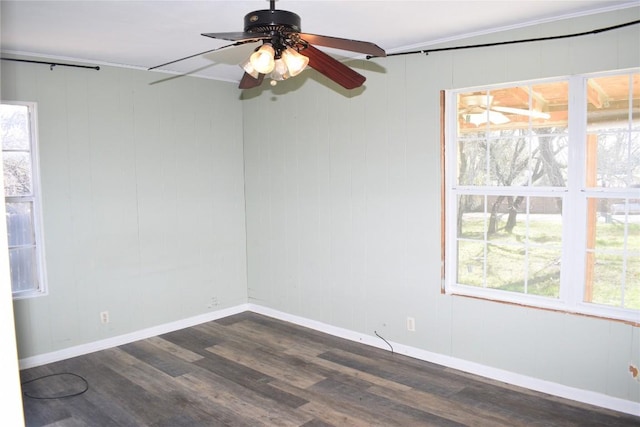 unfurnished room featuring dark hardwood / wood-style flooring, ceiling fan, and crown molding