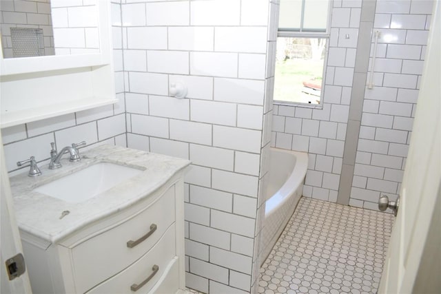 bathroom featuring tile patterned flooring, vanity, and tile walls