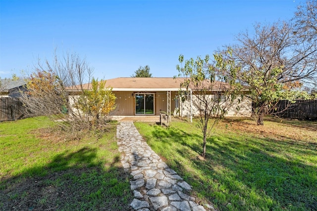 rear view of house featuring a yard