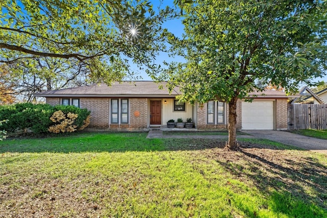 ranch-style house featuring a front yard and a garage