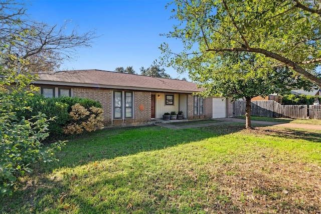 view of front of property featuring a front yard and a garage