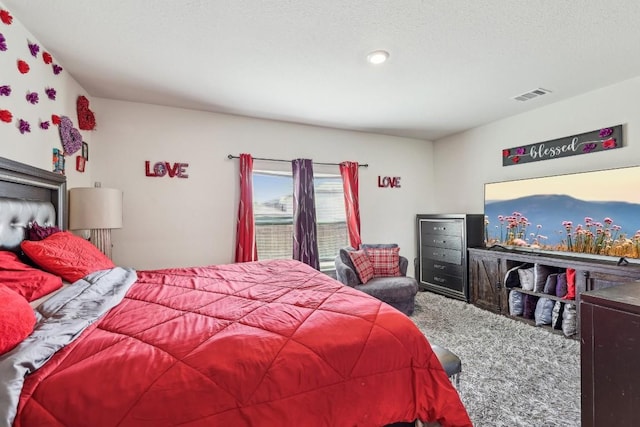 carpeted bedroom with a textured ceiling