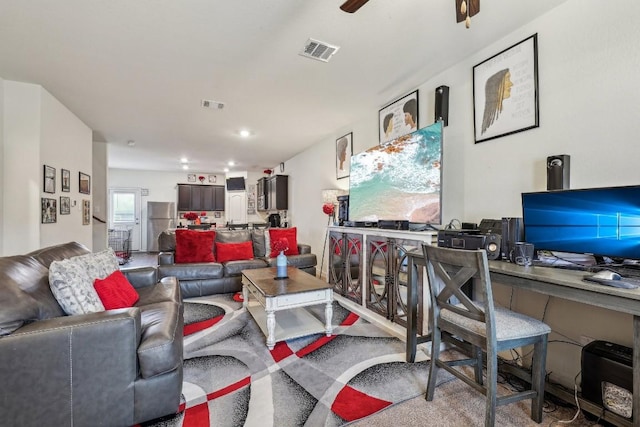 living room featuring ceiling fan and carpet