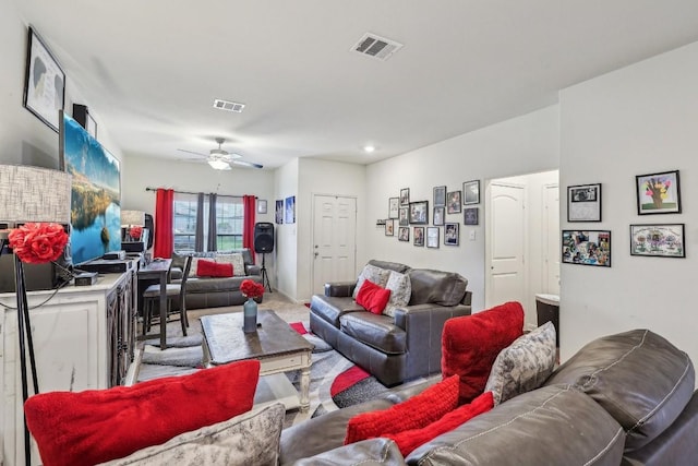 carpeted living room with ceiling fan