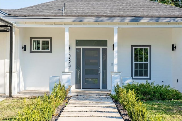 view of exterior entry featuring a porch