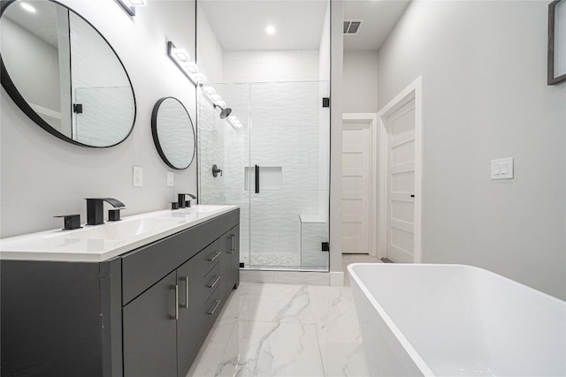 bathroom with vanity and separate shower and tub