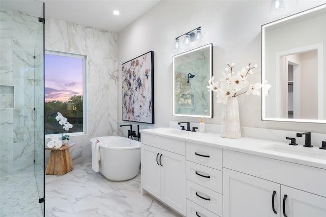 bathroom featuring vanity and shower with separate bathtub