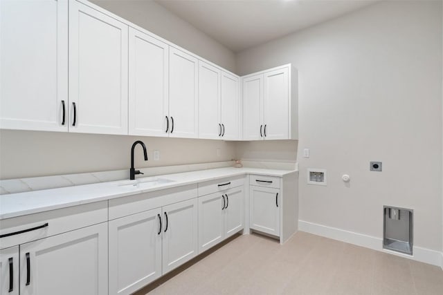 clothes washing area featuring sink, gas dryer hookup, cabinets, hookup for a washing machine, and electric dryer hookup