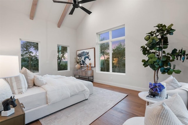 bedroom featuring ceiling fan, beam ceiling, high vaulted ceiling, and hardwood / wood-style floors