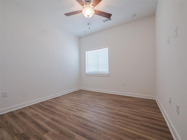 empty room with dark hardwood / wood-style floors and ceiling fan