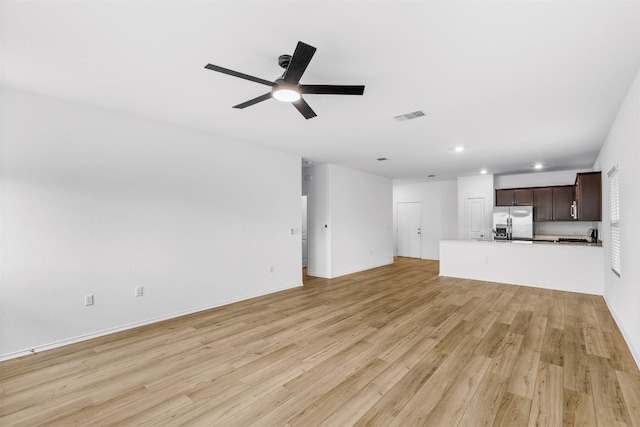 unfurnished living room featuring light hardwood / wood-style floors and ceiling fan