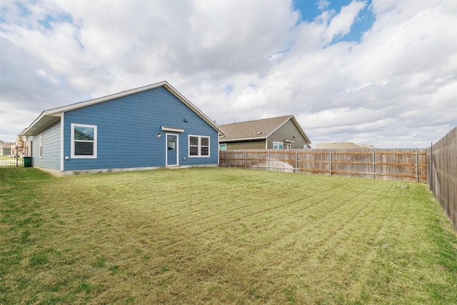 back of house with a lawn