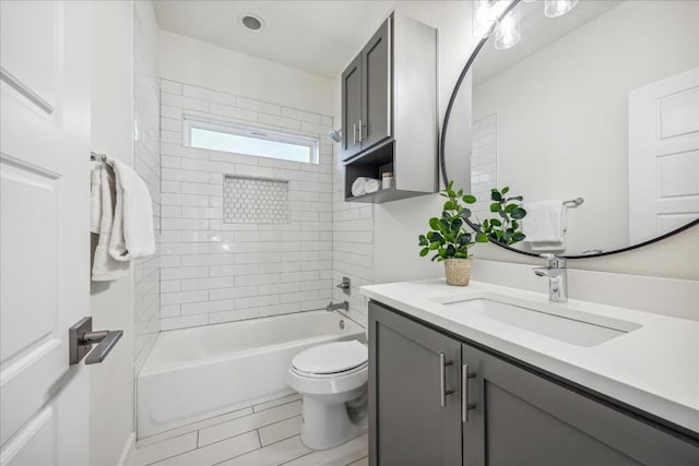 full bathroom with vanity, toilet, and tiled shower / bath combo