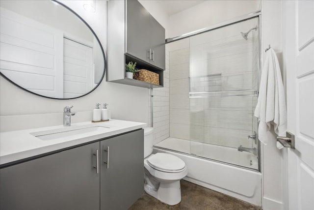 full bathroom featuring vanity, enclosed tub / shower combo, and toilet