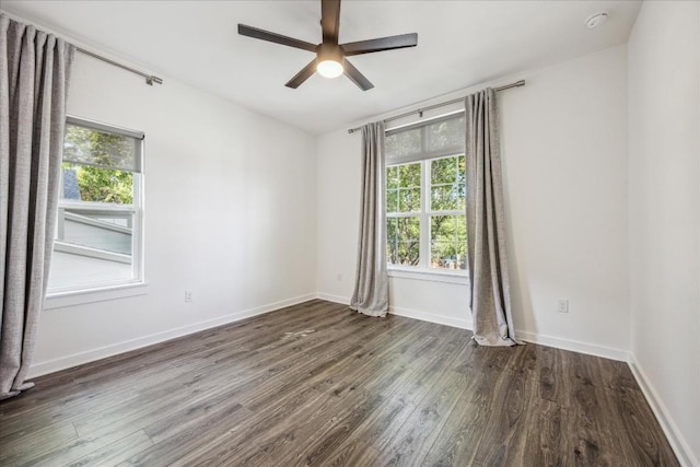 spare room featuring dark hardwood / wood-style floors and ceiling fan