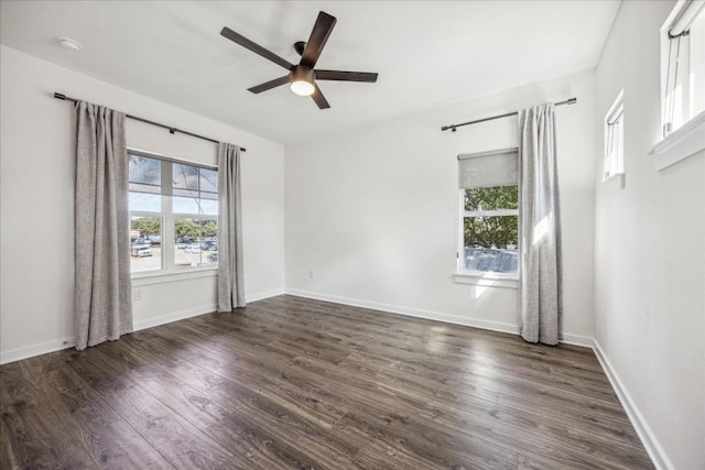 empty room with ceiling fan and dark hardwood / wood-style flooring