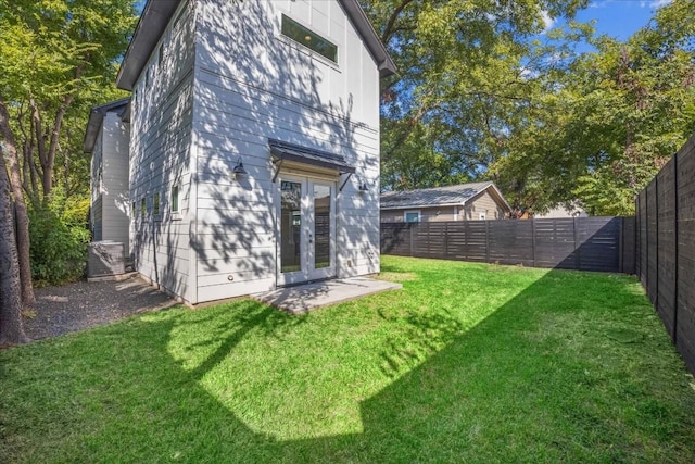 back of house with a yard and french doors