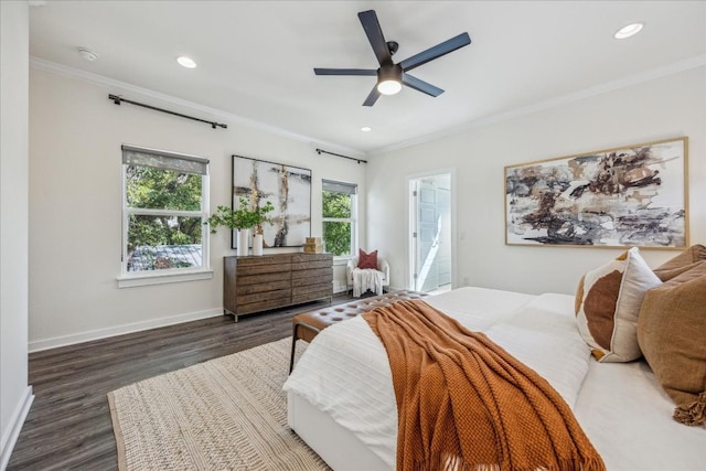 bedroom with ceiling fan, dark hardwood / wood-style floors, ornamental molding, and multiple windows