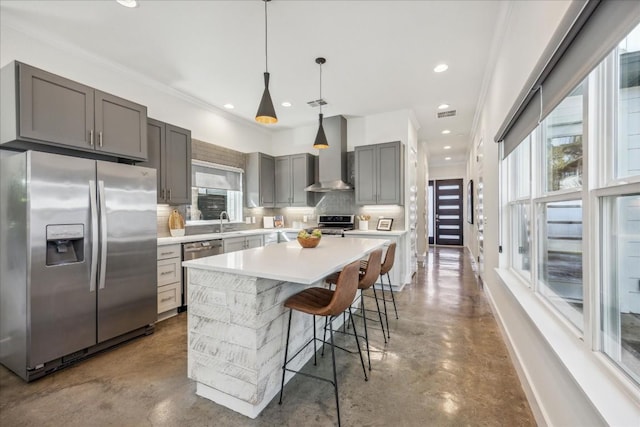 kitchen featuring sink, wall chimney exhaust hood, stainless steel appliances, backsplash, and concrete floors