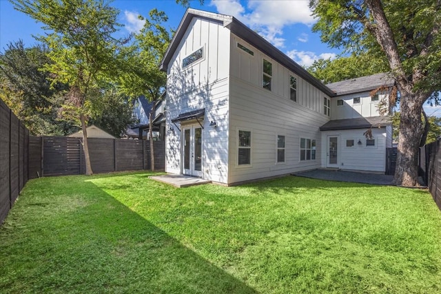 back of house featuring french doors, a yard, and a patio