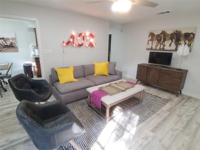 living room with ceiling fan and light hardwood / wood-style floors