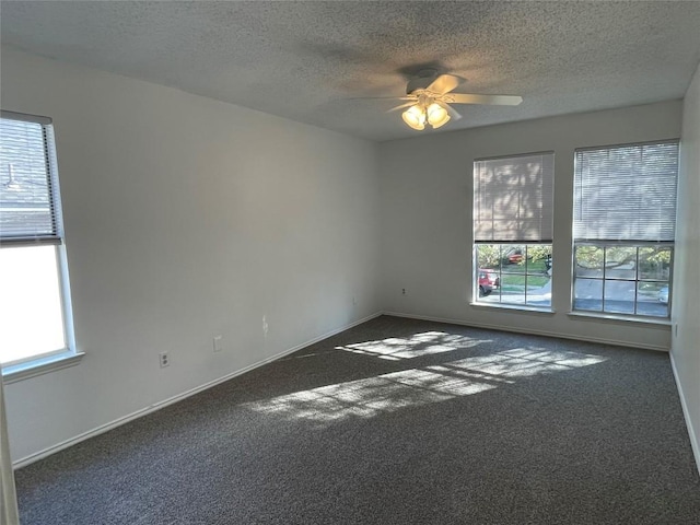 carpeted empty room featuring a textured ceiling and ceiling fan