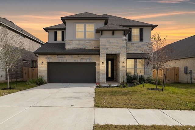 view of front of property featuring a yard and a garage