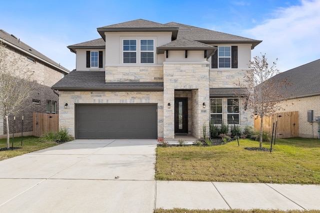 view of front of property with a garage and a front yard