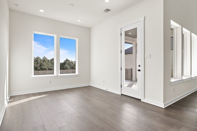 spare room featuring dark wood-type flooring