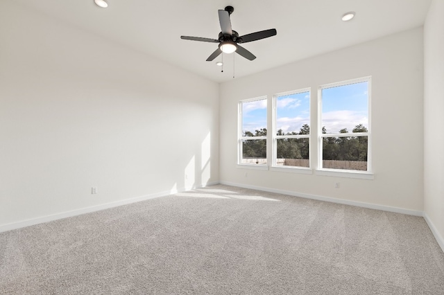 empty room with ceiling fan and carpet floors