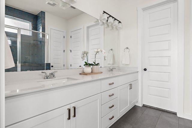 bathroom featuring tile patterned floors, vanity, and a shower with shower door