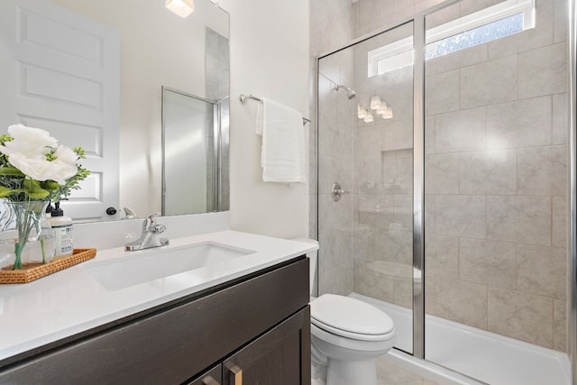 bathroom featuring vanity, toilet, and walk in shower