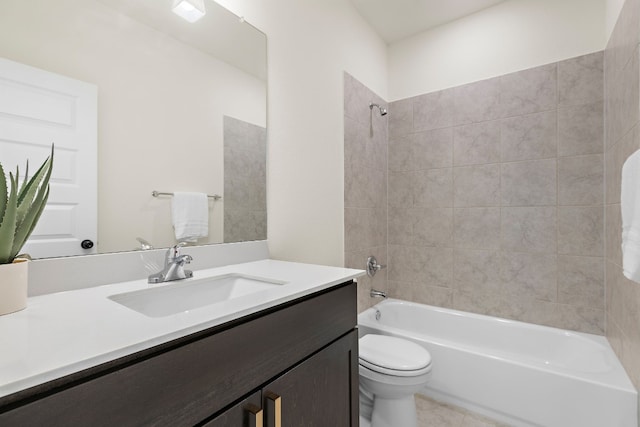 full bathroom featuring tiled shower / bath combo, toilet, and vanity