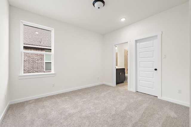 unfurnished room featuring light carpet