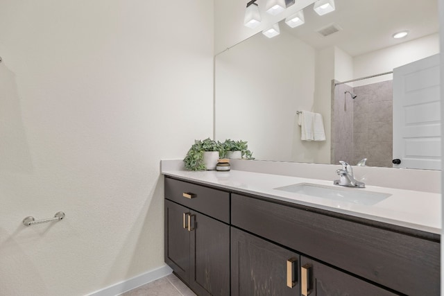 bathroom featuring a shower, vanity, and tile patterned floors