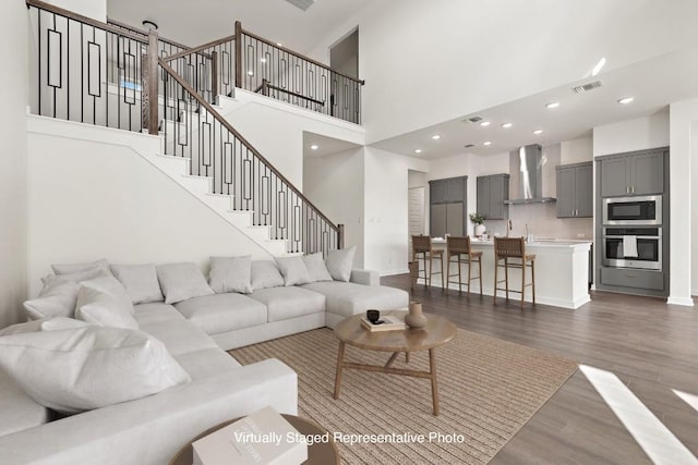 living room with dark hardwood / wood-style flooring and a high ceiling