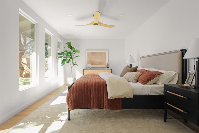 bedroom with ceiling fan and light wood-type flooring