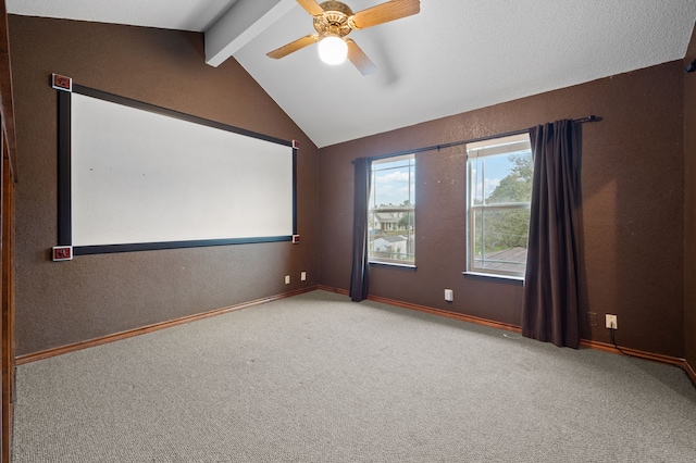 home theater featuring vaulted ceiling with beams, carpet floors, ceiling fan, and baseboards