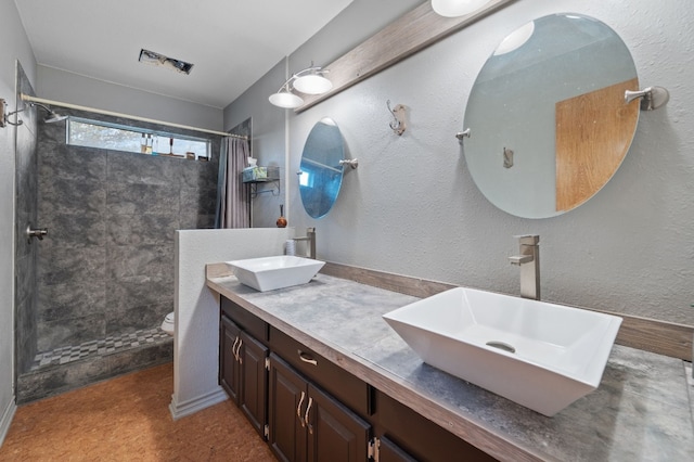 bathroom featuring vanity, toilet, and curtained shower