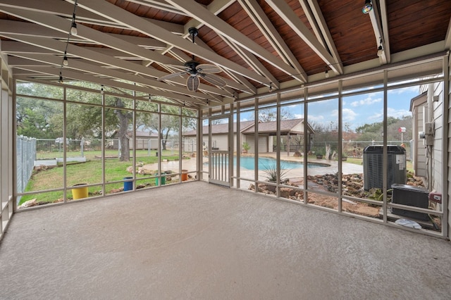 unfurnished sunroom with vaulted ceiling and ceiling fan